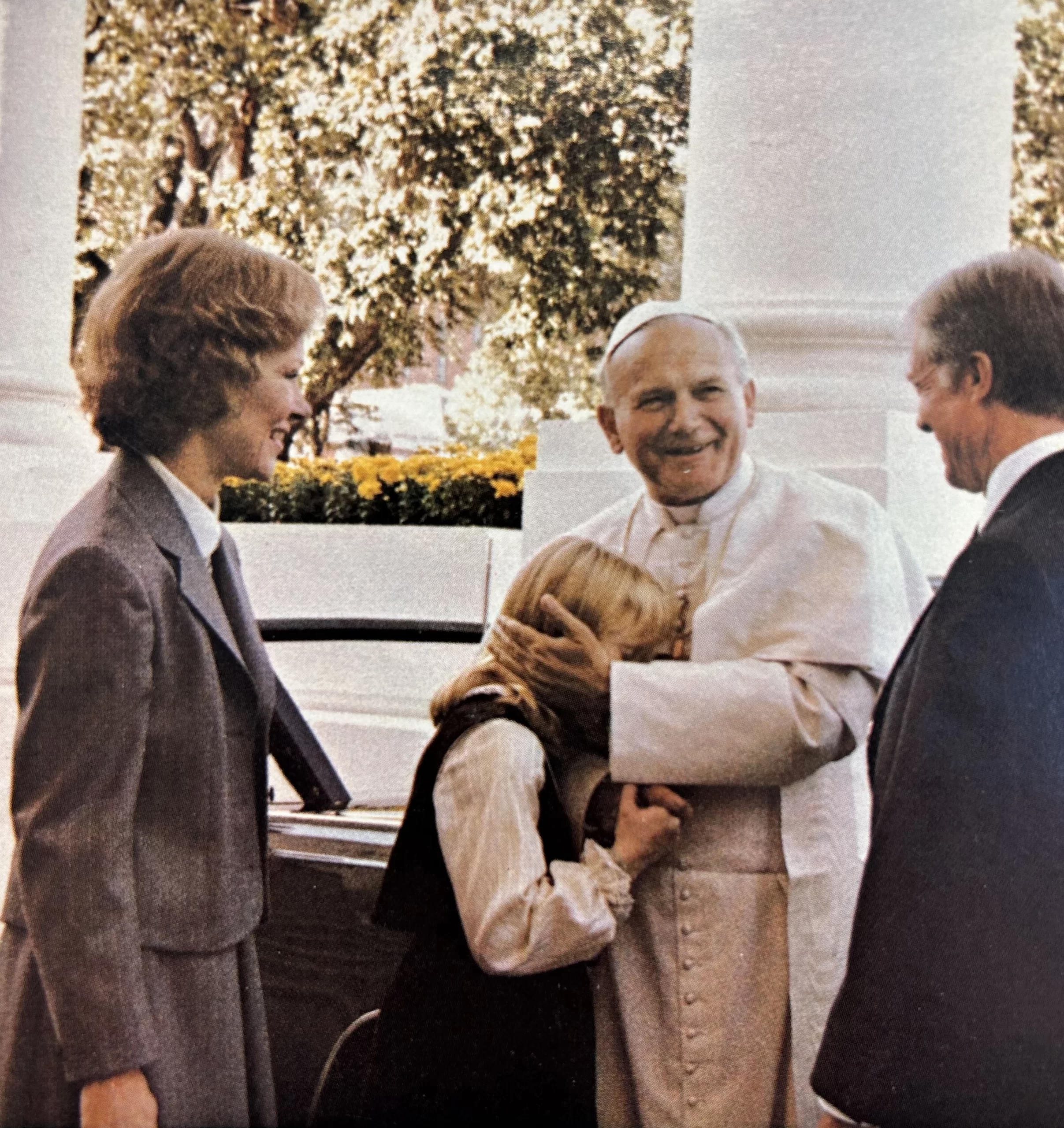 As a beaming U.S. President Jimmy Carter and First Lady Rosalynn Carter look on, Pope John Paul II greets then-11-year-old First Daughter Amy Carter upon arriving at the White House on Oct. 6, 1979. Credit: U.S. Government Printing Office