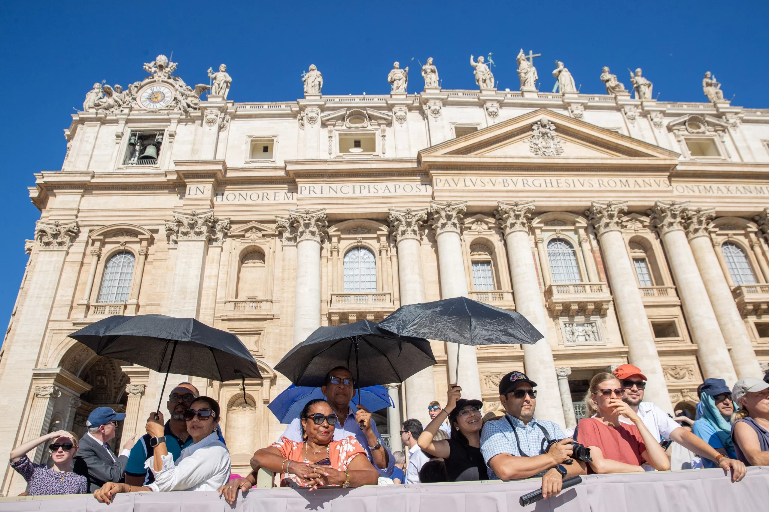 Pilgrims shield themselves from the sun at the pope's general audience in St. Peter's Square at the Vatican, Wednesday, June 26, 2024. Credit: Daniel Ibanez/CNA