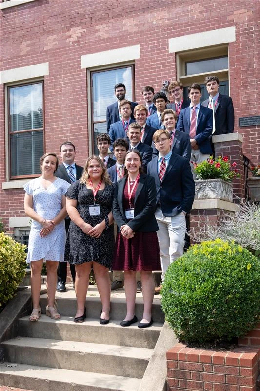 High school students participating in Belmont Abbey's Colloquium on Catholic Statesmanship in 2023 pose for a group photo on the steps outside the original Belmont House. Credit: Belmont Abbey College