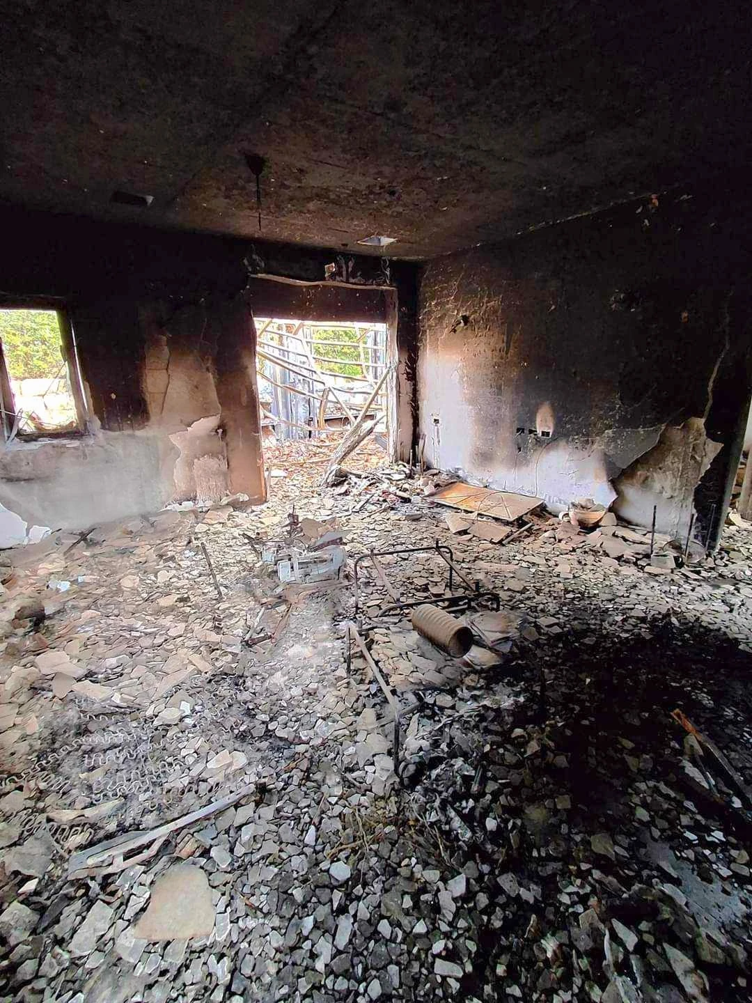 The living room of Ester Rot's home in Kibbutz Be'eri, where Monica Biboso lived and worked as a caregiver for the elderly woman. The house was completely burned down during the Hamas attack on Oct. 7, 2023. The photo was taken by Biboso when she had the chance to return in January 2024. Credit: Photo courtesy of Monica Biboso