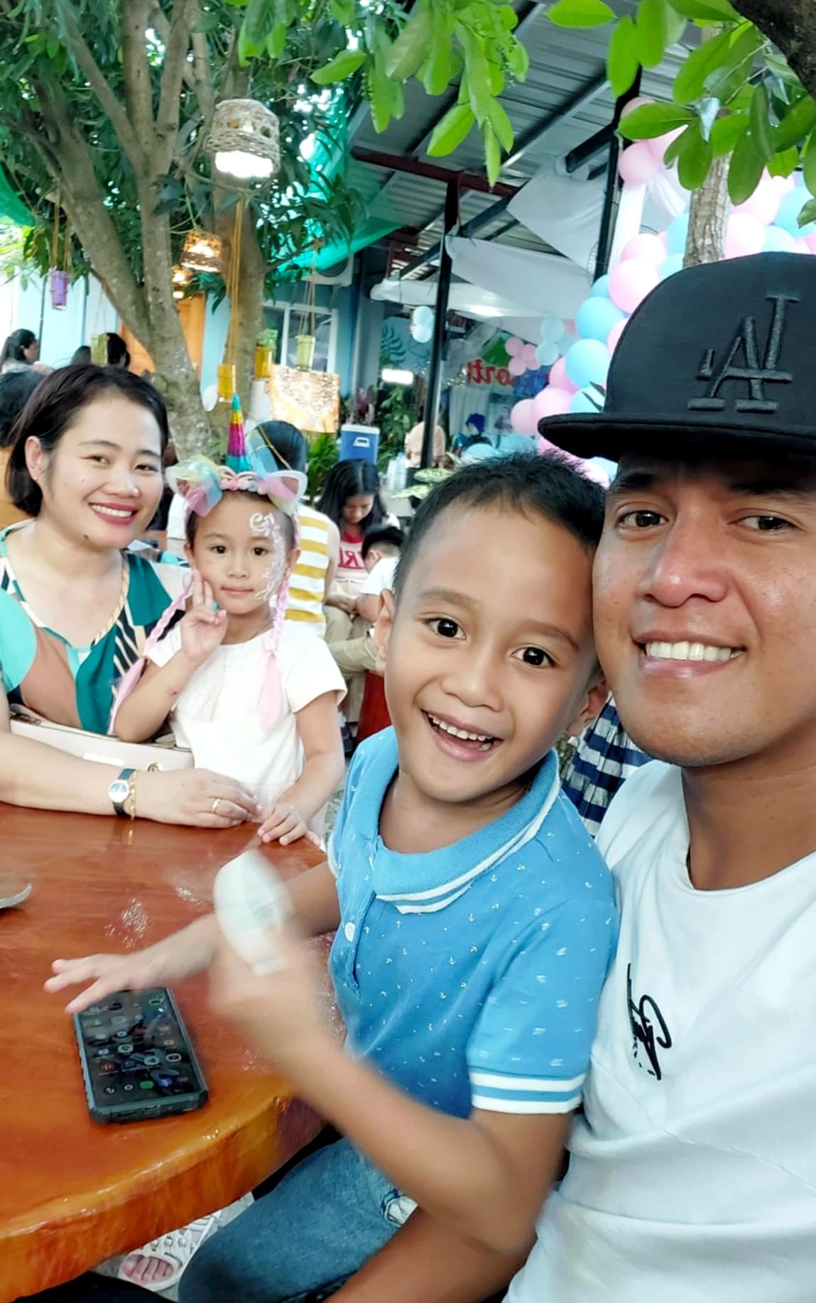 Monica Biboso with her family in the Philippines in April 2024: her husband, Roberto; her daughter, Sofya; and her son, Clarence. In the first few hours of the Oct. 7, 2023, massacre by Hamas, she managed to stay in touch with them, then her cellphone ran out of power. “When I was able to turn my phone back on, I found video messages from my children, crying, kissing and telling me to take care of myself.” Credit: Photo courtesy of Monica Biboso