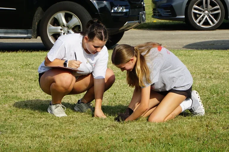 Students from Sacred Heart Academy in Louisville, Kentucky, work to identify a gravesite in Meadow View Cemetery, Sept. 21, 2024. Credit: The Record/Ruby Thomas