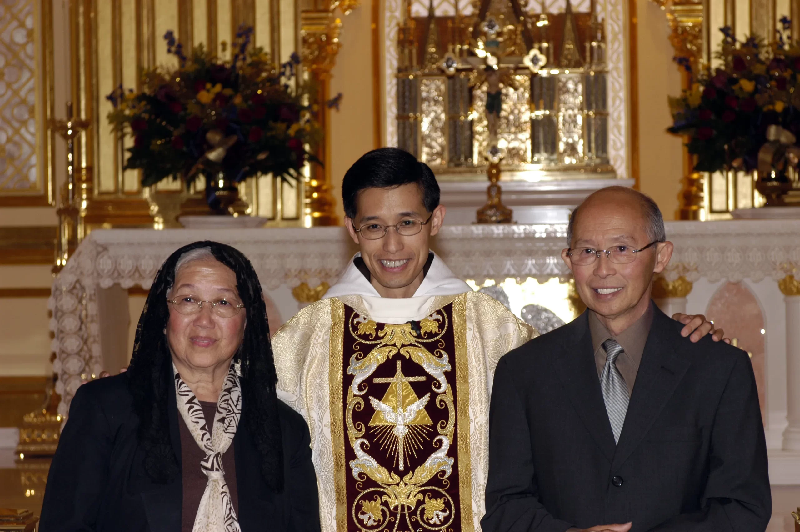 Father Miguel with his mother and father at his first Mass in 2004. Credit: Father Miguel