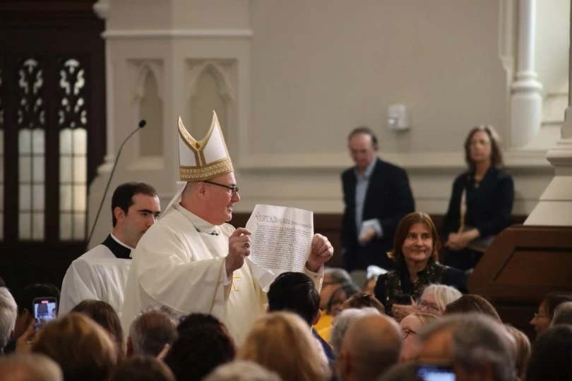 Archbishop Richard Henning shows the letter of his appointment to the congregation during his Oct. 31, 2024, installation Mass at Boston’s Cathedral of the Holy Cross. Credit: Andrzej Skonieczny