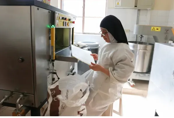 After the dough is made, the next stage is to make the templates using a machine. Credit: Eduardo Berdejo / EWTN News.