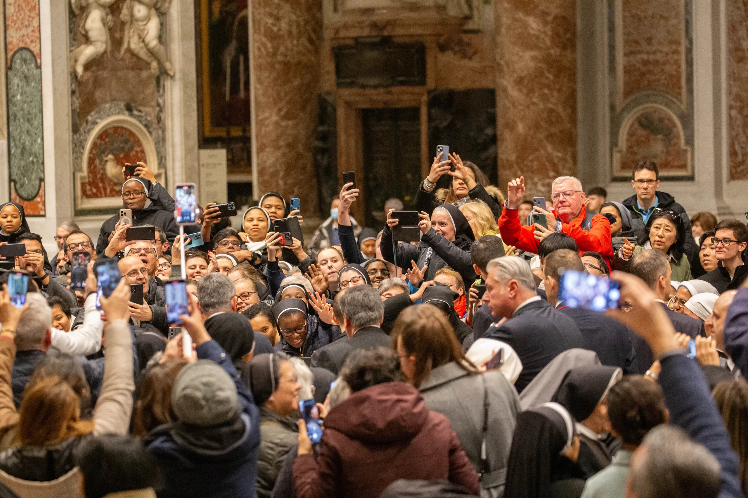 Consecrated men and women capture moments from Pope Francis’ passage through St. Peter’s Basilica during the celebration of first vespers, Vatican City, Feb. 1, 2025. Credit: Anhelina Martsisheuskaya/CNA