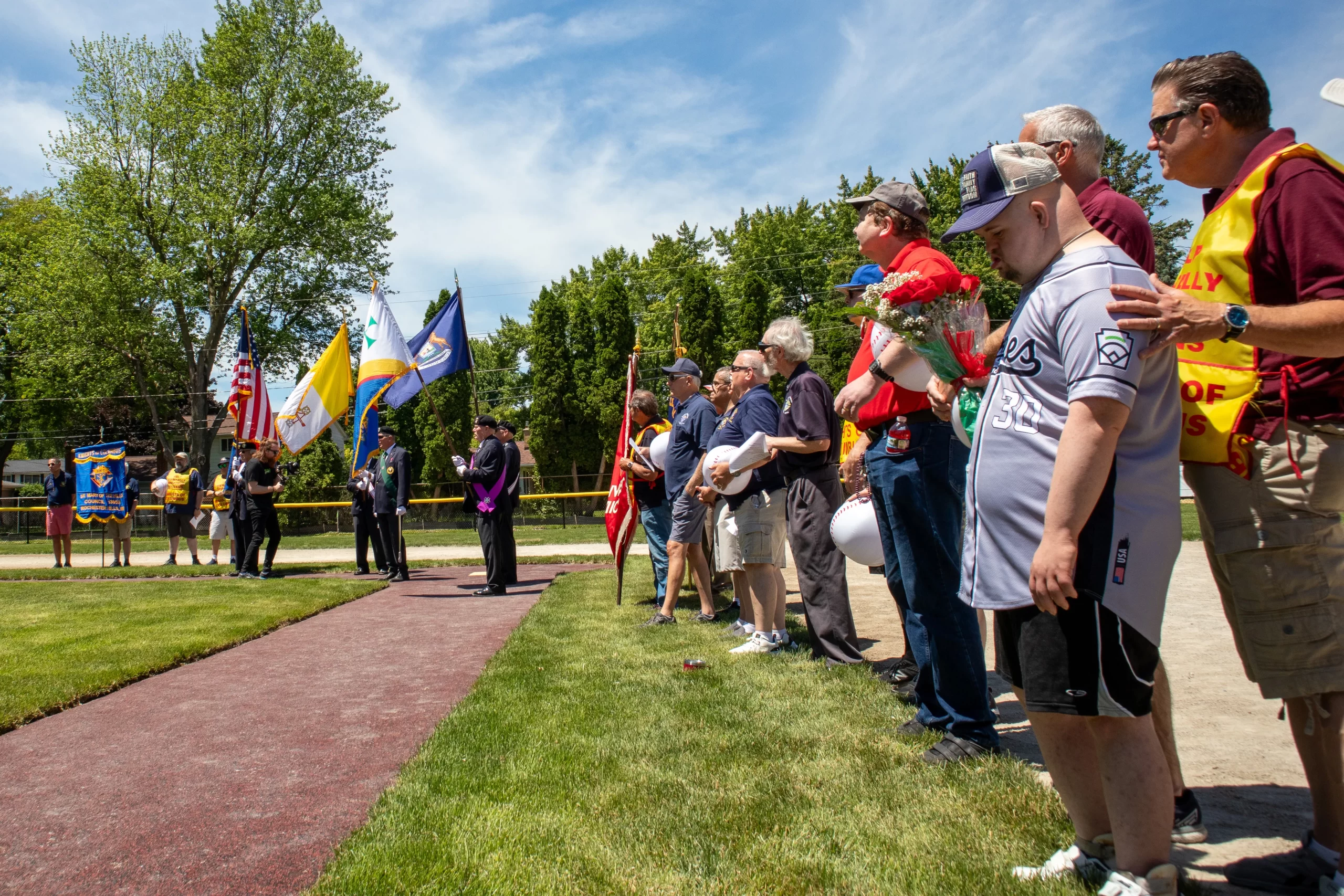 Knights and athletes participate in the dedication ceremony of the new McGivney Field in Clinton Township, Michigan, on June 15. The field has special features to make it accessible to players with disabilities, including wide, rubberized base paths. Credit: Jonathan Francis