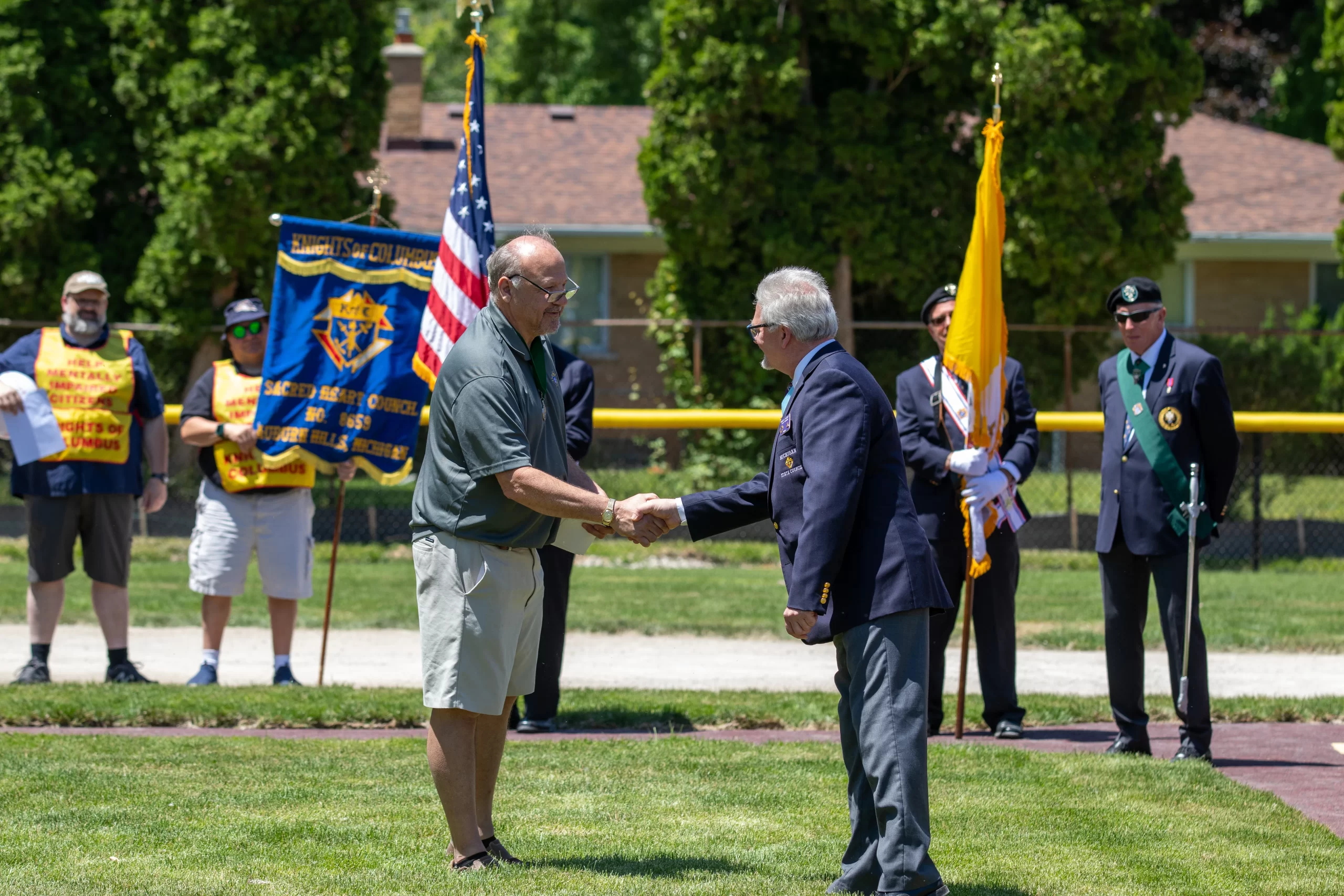 Ken Dumais of St. Mary of the Hills Council 13950 in Rochester Hills greets Michigan State Secretary Charles McCuen at the dedication of the new McGivney Field on June 15, 2024. More than 40 K of C councils donated more than $ 60,000 to build the field; Dumais led those efforts. Credit: Jonathan Francis