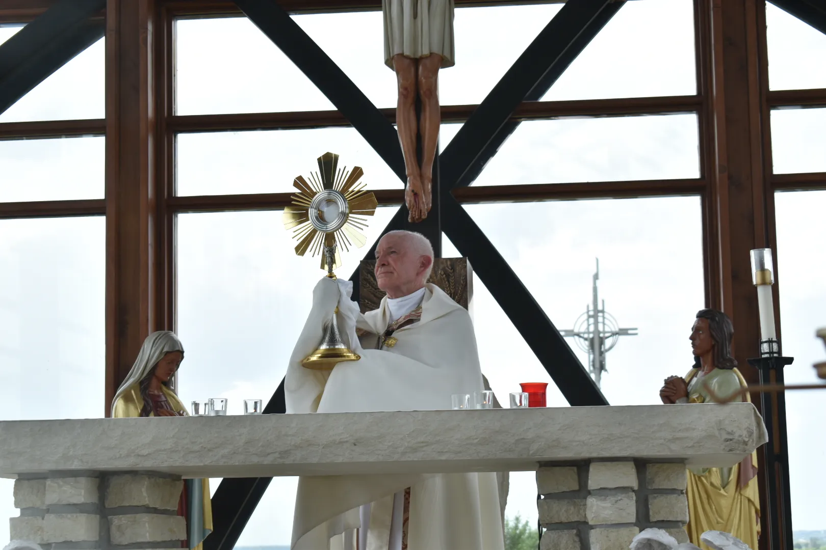 Archbishop George Lucas of Omaha raises the monstrance in Benediction at the Holy Family Shrine on June 21, 2024. Credit: Kate Quiñones/CNA
