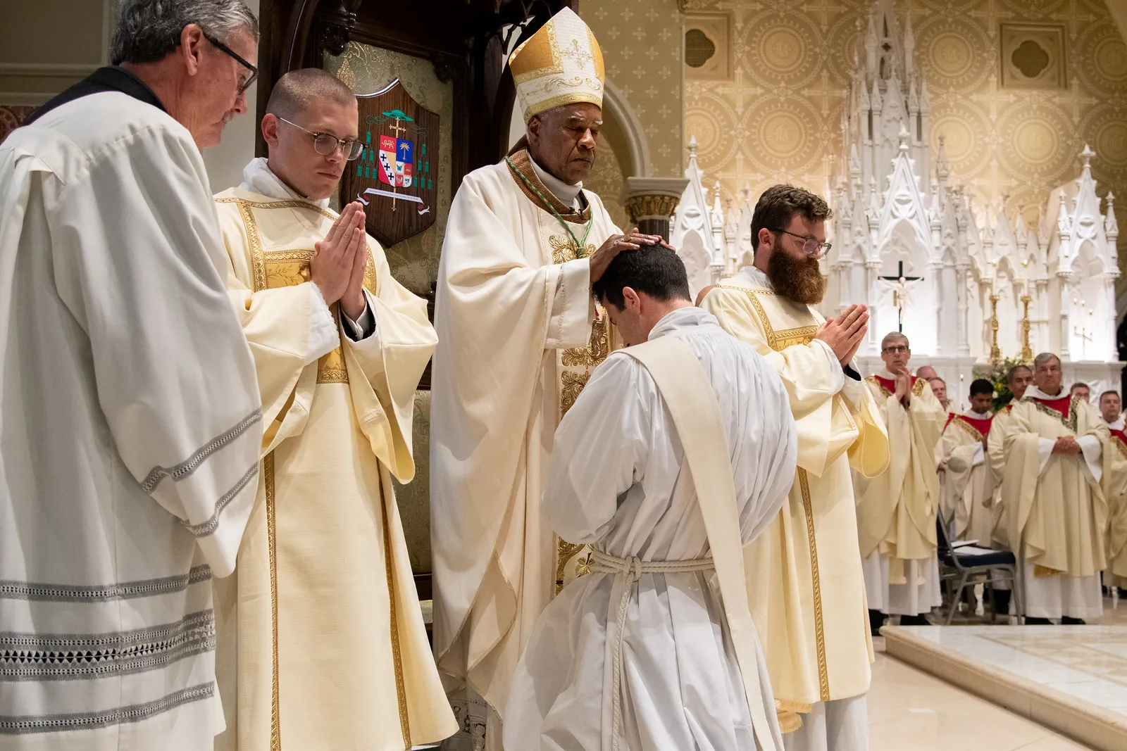 Bishop Jacques Fabres-Jeune lays his hands upon a newly-ordained priest on June 7, 2024, at the Cathedral of St. John the Baptist in Charleston, South Carolina. Credit: The Catholic Miscellany/Doug Deas