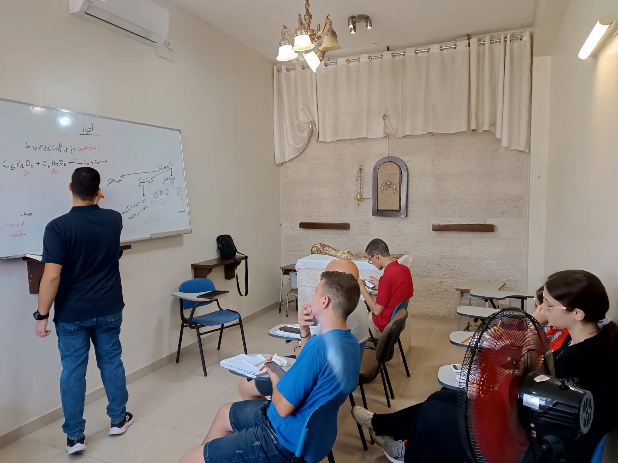 A math review for the young people from Gaza in the chapel of the Sisters of the Incarnate Word, inside the compound of the Latin parish. Organizing the project hasn’t been easy. There isn’t a free space in the Catholic compound. But the parish priest, Father Gabriel Romanelli, doesn’t lack initiative. The chapel, the kitchen, the living room, and the balcony of the Sisters of the Incarnate Word’s house have all become “classrooms”; three gazebos in the garden host study groups. Even the parish church hosts a group. Credit: Photo courtesy of Father Gabriel Romanelli