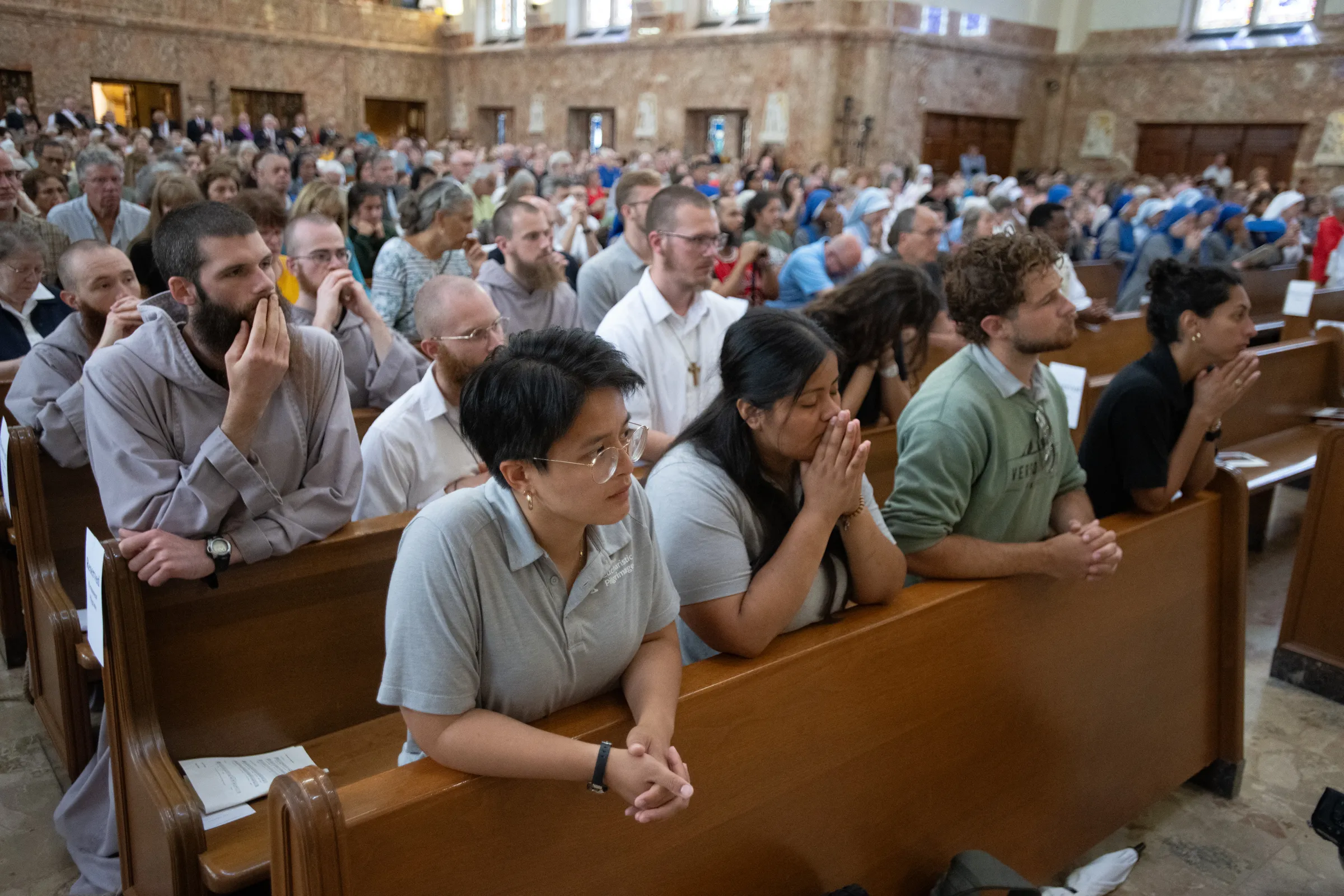 The "Perpetual Pilgrims" on the Seton Route of the National Eucharistic Pilgrimage kneel at Mass on June 6, 2024. Credit: Jeffrey Bruno