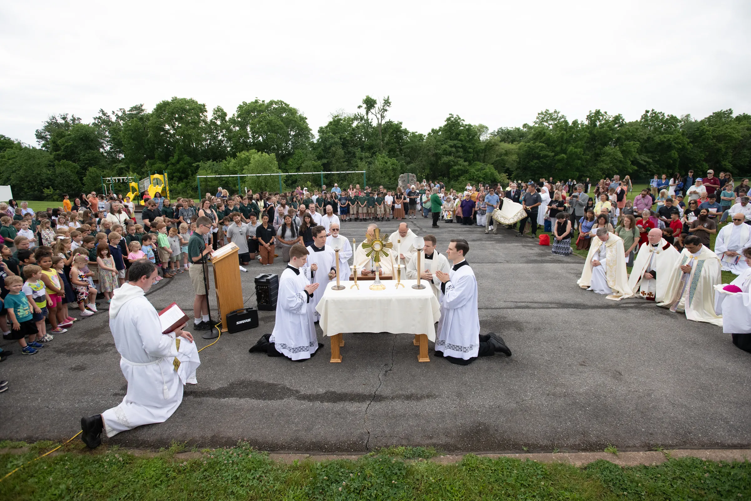 The priests prepare the Eucharist for adoration on the school's blacktop. Credit: Jeffrey Bruno