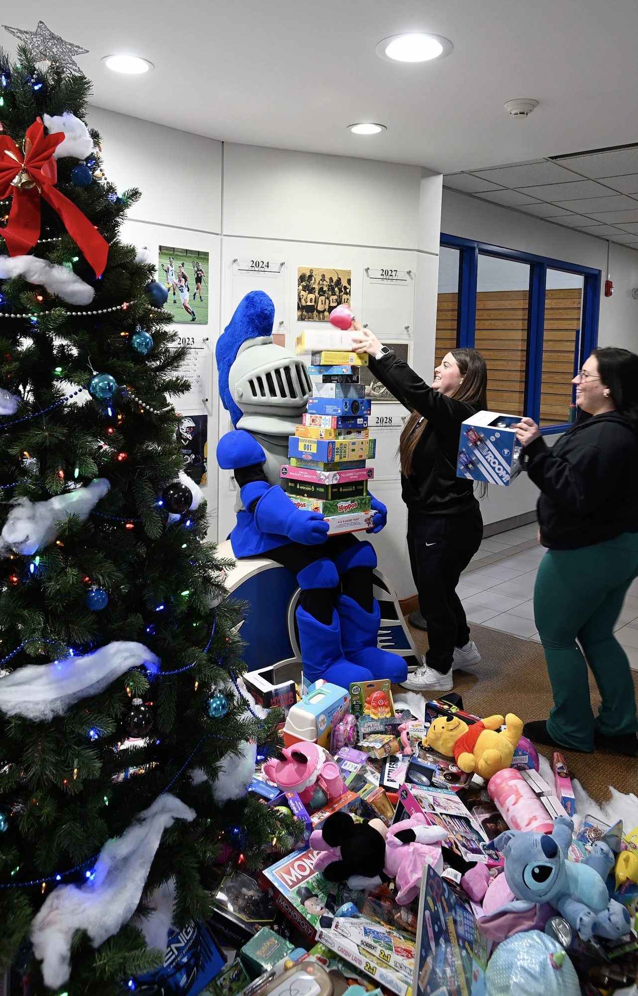 A volunteer stacks toys at Mount Saint Mary College as part of the school's annual toy drive in Newburgh, New York, December 2024. Credit: Lee Ferris