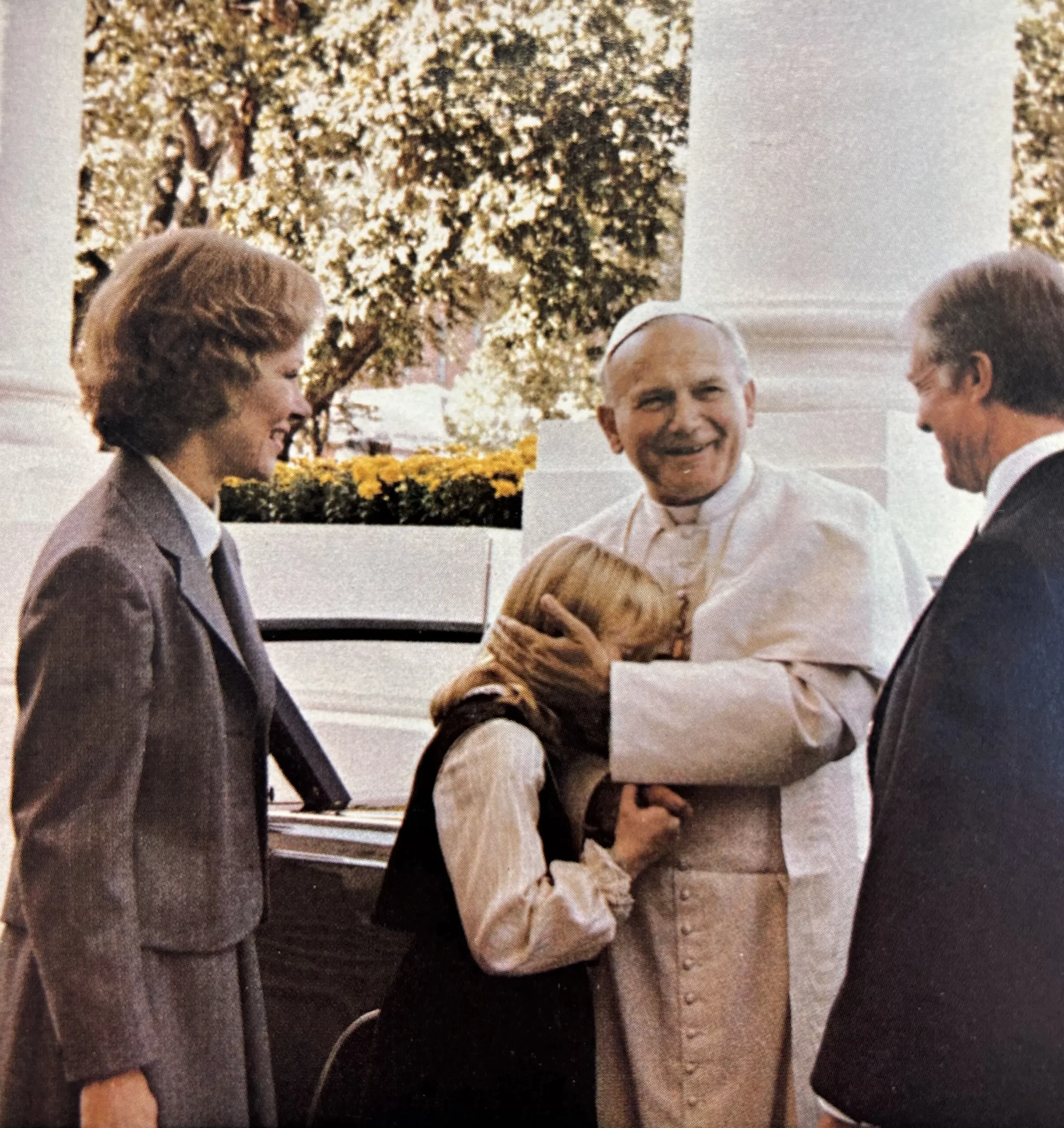 As a beaming U.S. President Jimmy Carter and First Lady Rosalynn Carter look on, Pope John Paul II greets then 11-year-old First Daughter Amy Carter upon arriving at the White House on Oct. 6, 1979. Credit: U.S. Government Printing Office