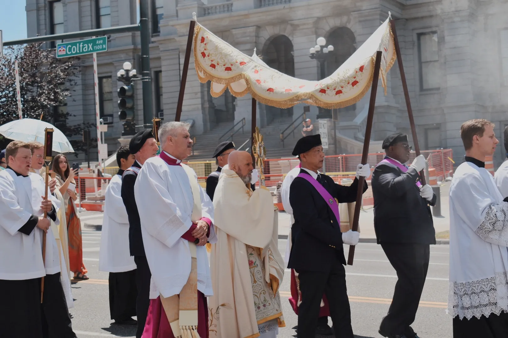 Archbishop Samuel Aquila carries the monstrance down Colfax Avenue in downtown Denver on June 9, 2024. Credit: Kate Quiñones/CNA