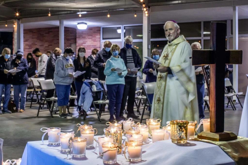 Los Angeles Auxiliary Bishop David O'Connell looks at candles placed on an altar representing people who lost their lives during the coronavirus pandemic during a nondenominational memorial service in Long Beach, California, on Nov. 14, 2020. Credit: Apu Gomes/AFP via Getty Images