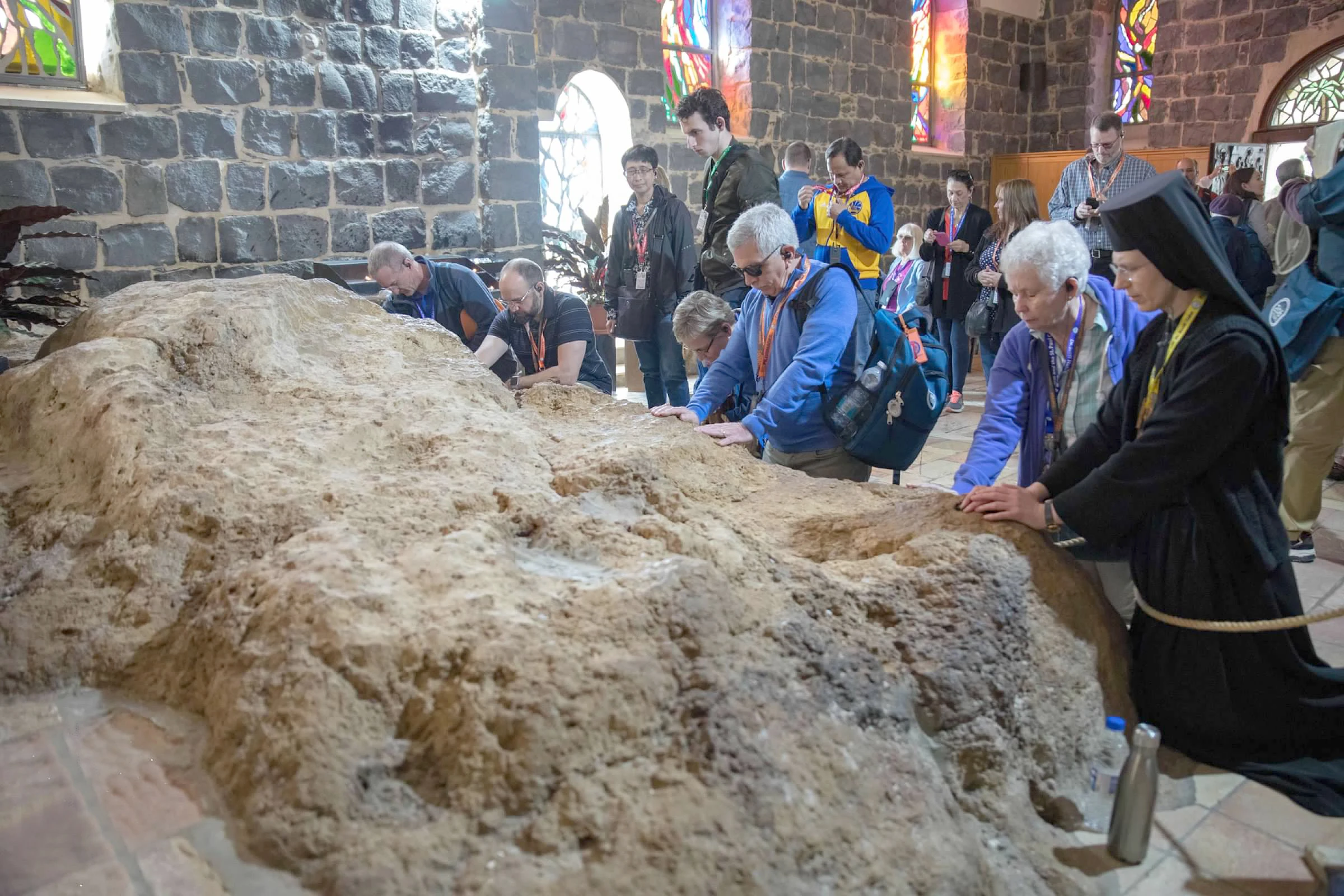 Pilgrims on a pilgrimage organized by 206 Tours kneel in the Church of the Primacy of Saint Peter in Tabgha, Israel. Credit: Photo courtesy of 206 Tours