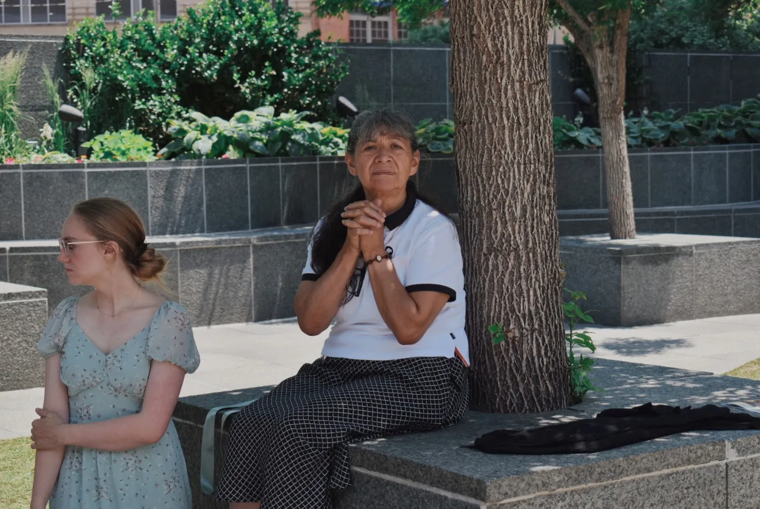 Two women wait for the approaching monstrance outside Holy Ghost Church on June 9, 2024. Credit: Kate Quiñones/CNA