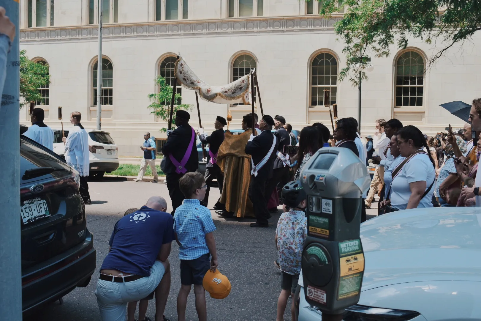 One man kneels in prayer with his family as the Eucharist reaches Holy Ghost Church in Denver on June 9, 2024. Credit: Kate Quiñones/CNA