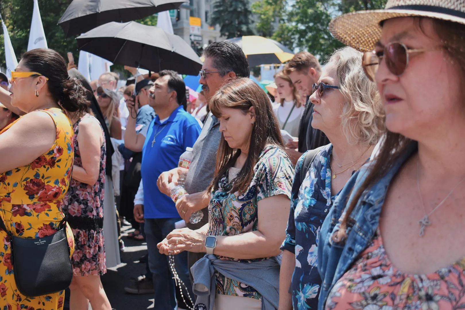 Members of the Denver Eucharistic procession pray and sing. Credit: Kate Quiñones/CNA