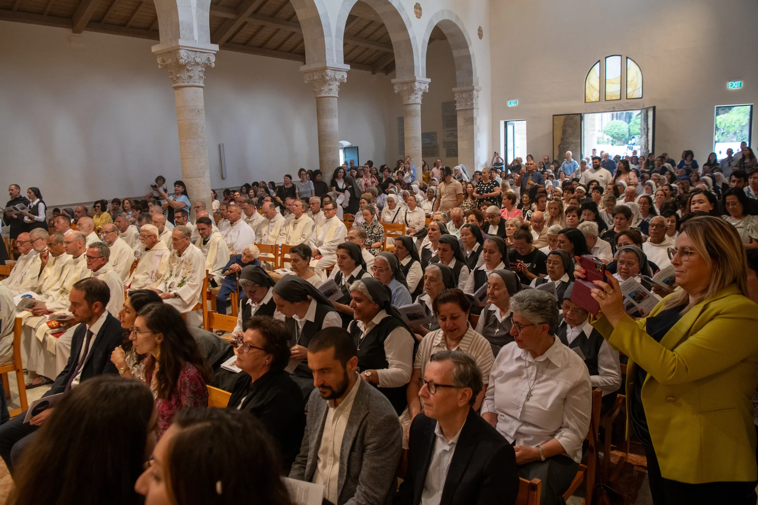 Hundreds of local faithful from Jerusalem and Galilee attend the solemn Mass with the rite of dedication of the altar, marking the reopening of the Church of Our Lady of the Ark of the Covenant in Kiryat Yearim, on Aug. 31, 2024. A hundred years ago, Sister Josephine Rumèbe of the Sisters of St. Joseph of the Apparition wrote about having seen a vision of "a crowd rushing toward the basilica. I saw priests, sisters of our order, and then men and women of the world who were even more pleasing to God than all the others, holy souls shining like stars.” Credit: Marinella Bandini