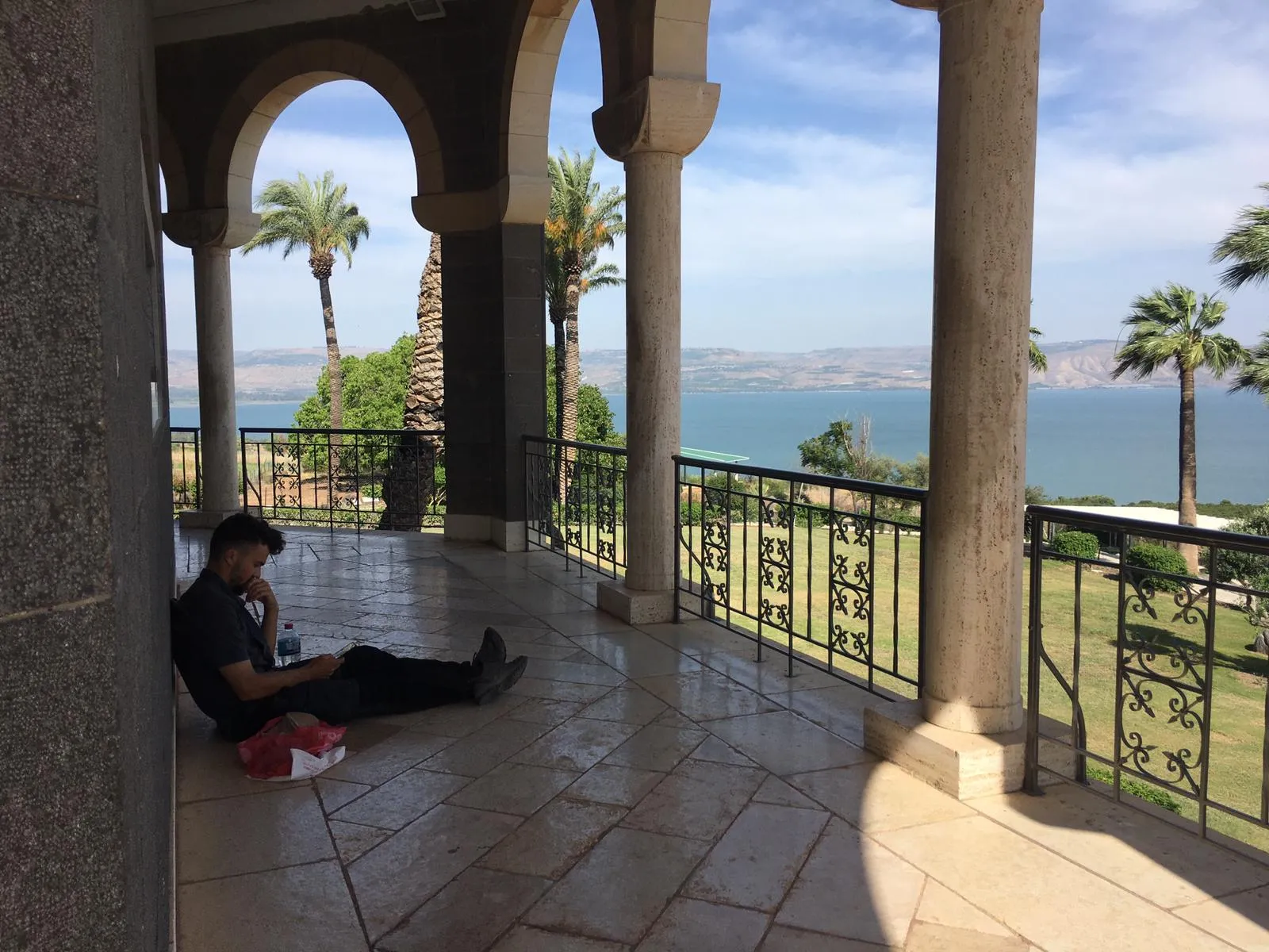 The French pilgrims rest under the portico of the Church of the Beatitudes on a hill overlooking the Sea of Galilee. In the photo is Louis Antona. A journey like this isn't for everyone, but, the three young people said, “if God calls you, go in peace. If God helps you, everything becomes possible.” Credit: Photo courtesy of French pilgrims Madeleine and Marie-Liesse