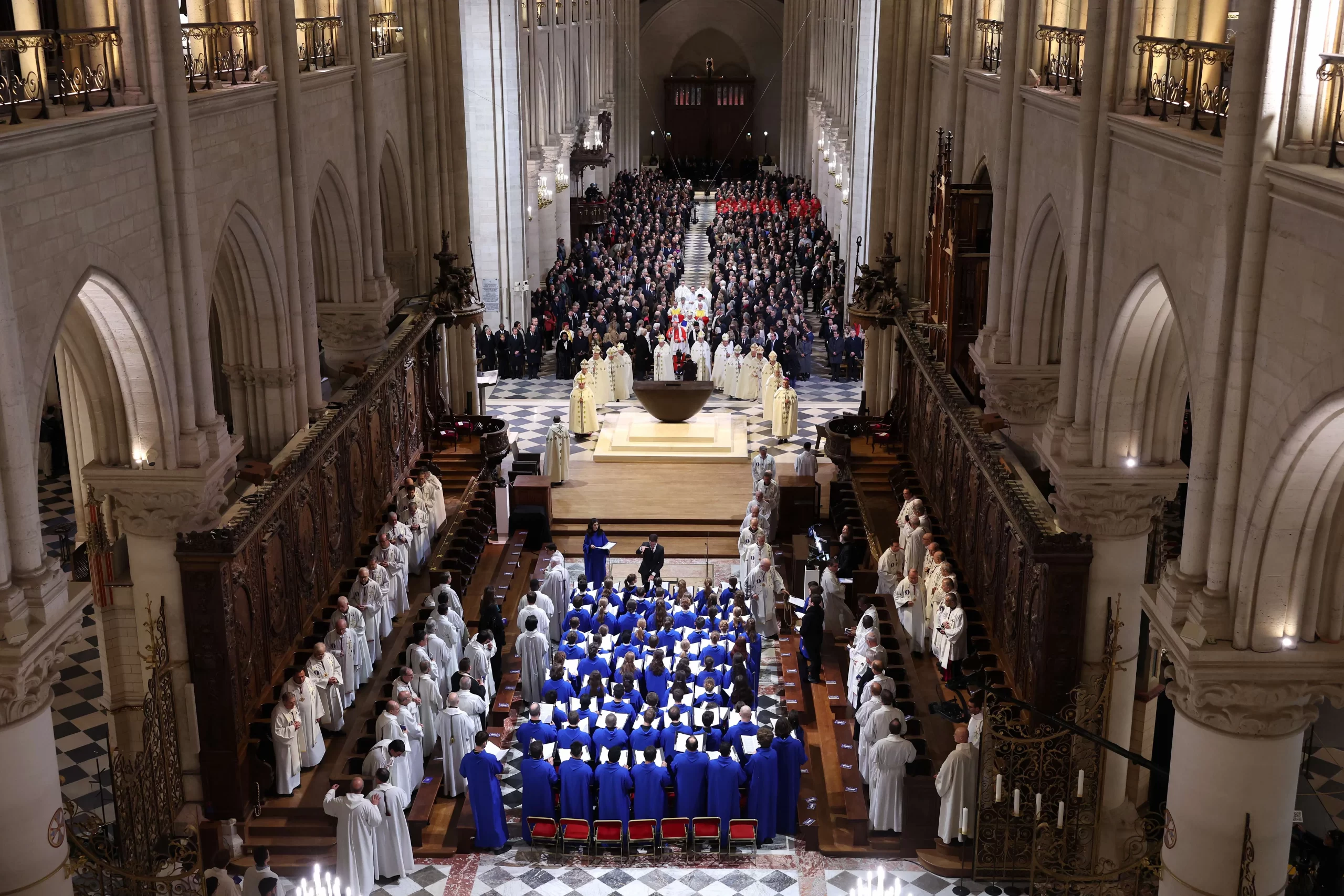 The choir, clergy, and guests stand during the ceremony to mark the reopening of Notre-Dame of Paris Cathedral on Dec. 7, 2024, in Paris. After five years of restoration, Notre-Dame Cathedral in Paris reopened its doors to the world in the presence of Emmanuel Macron and about 40 heads of state, including President-elect Donald Trump, invited for the occasion. Credit: Pascal Le Segretain/Getty Images for Notre-Dame de Paris