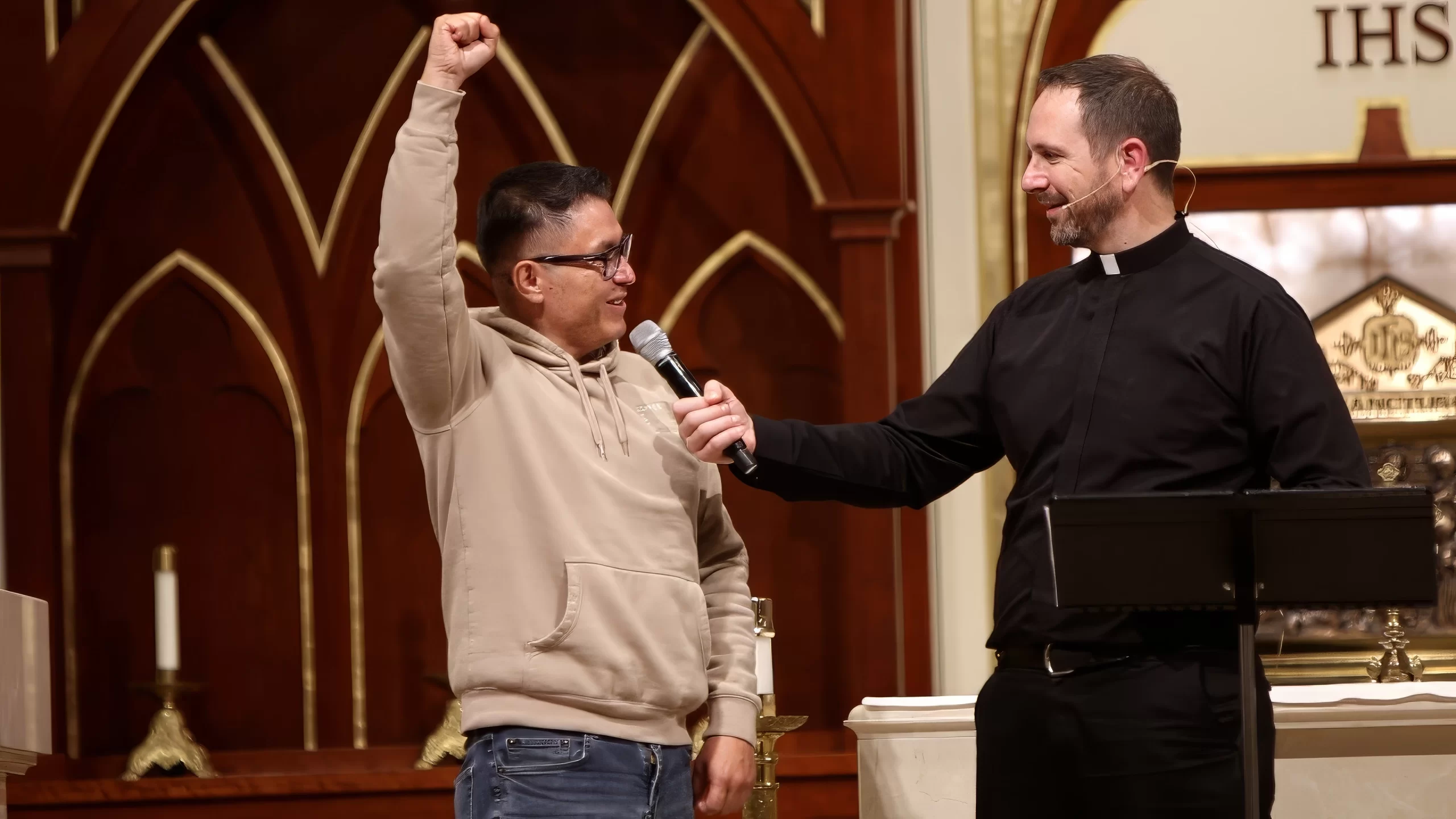 Father Mathias Thelen receives testimony from a man experiencing relief from shoulder pain at a healing service on Dec. 6, 2024, at St. Patrick Church in Brighton, Michigan. Credit: Photo courtesy of Jessica Morehead