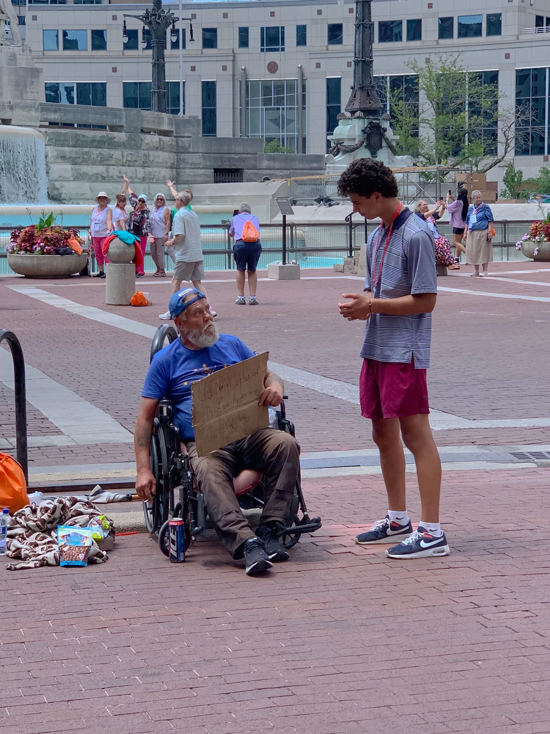 A participant chatting with a homeless man during the 2024 National Eucharistic Congress in Indianapolis, Indiana. July 2024. Credit: Jonah McKeown/CNA