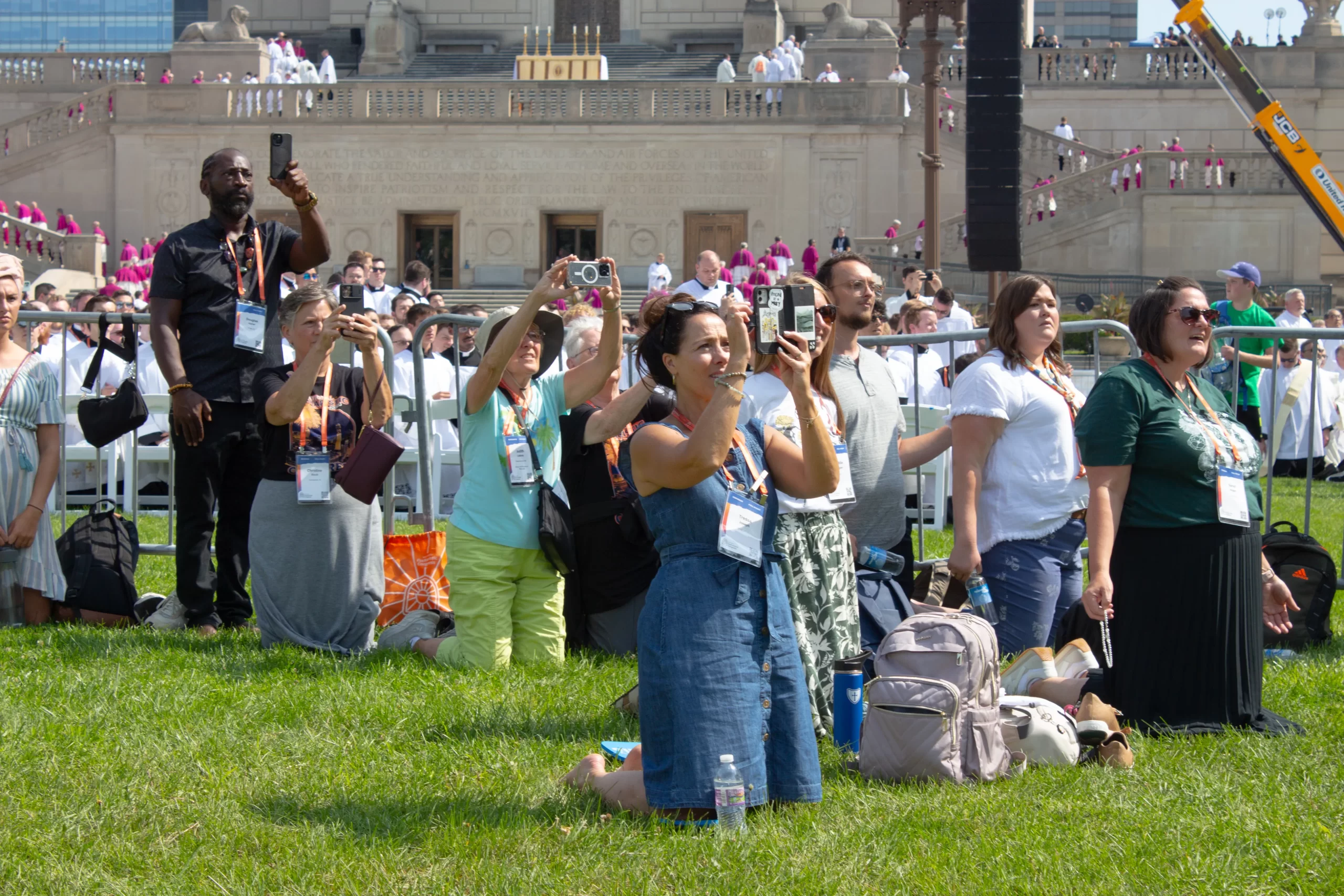 Participants kneel and take pictures as the Eucharist approaches the Indiana War Memorial. Credit: Jonah McKeown/CNA