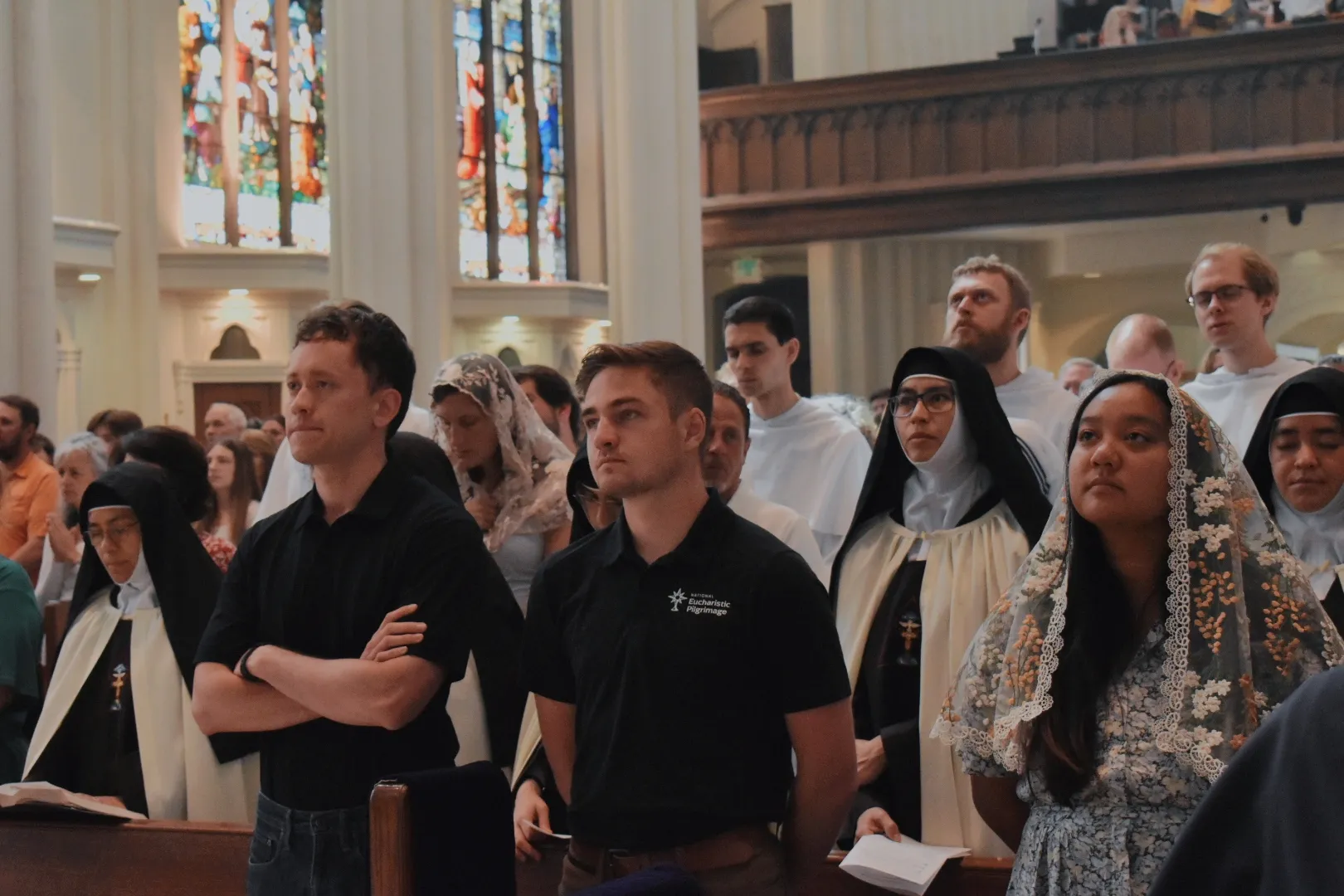 Jack Krebs (center) and other National Eucharistic Procession pilgrims attend Mass at the Cathedral Basilica of the Immaculate Conception in Denver on June 9, 2024. Credit: Kate Quiñones/CNA