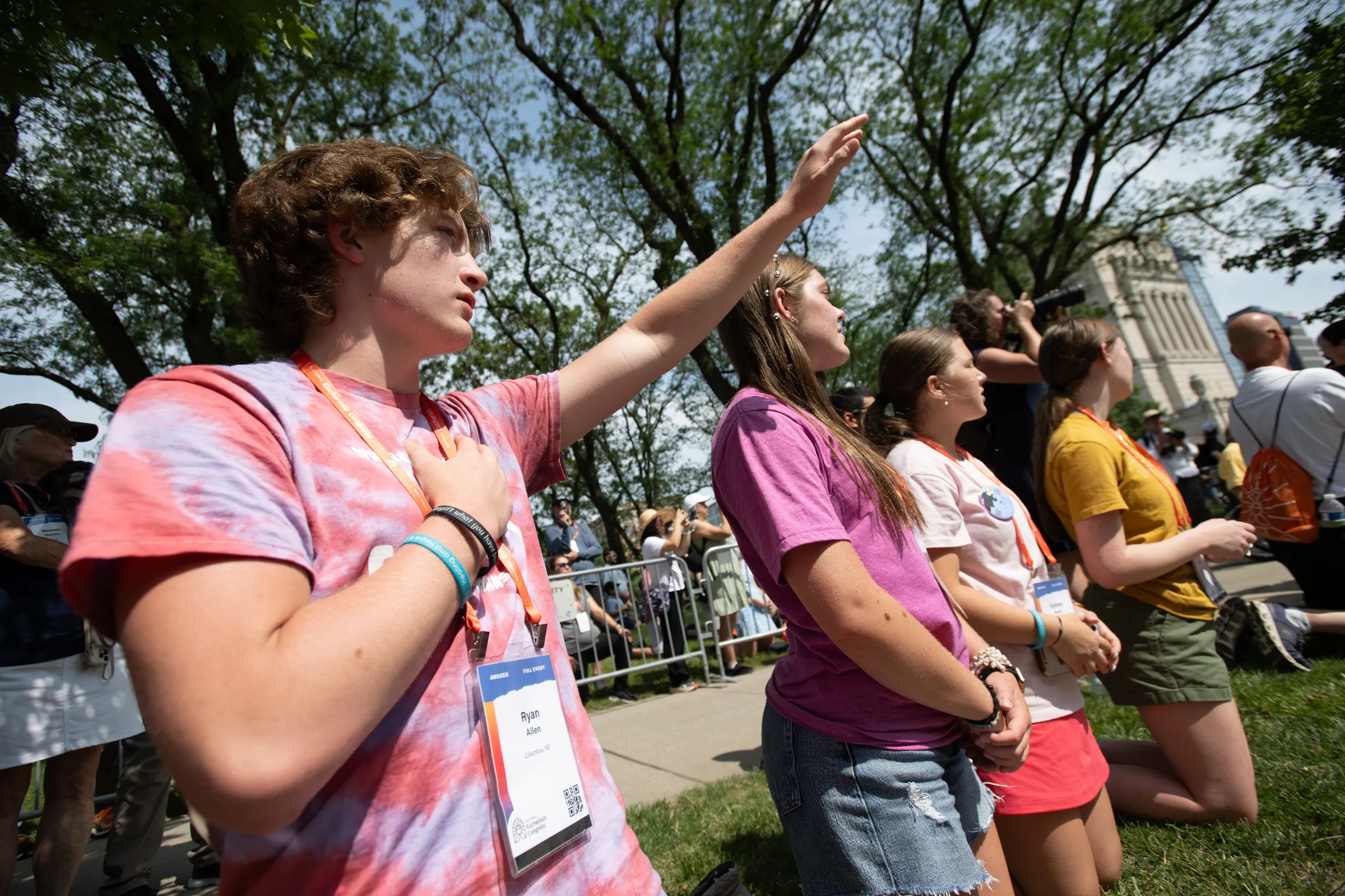 Young participants kneel as the Eucharist passes by in downtown Indianapolis. Credit: Jeffrey Bruno