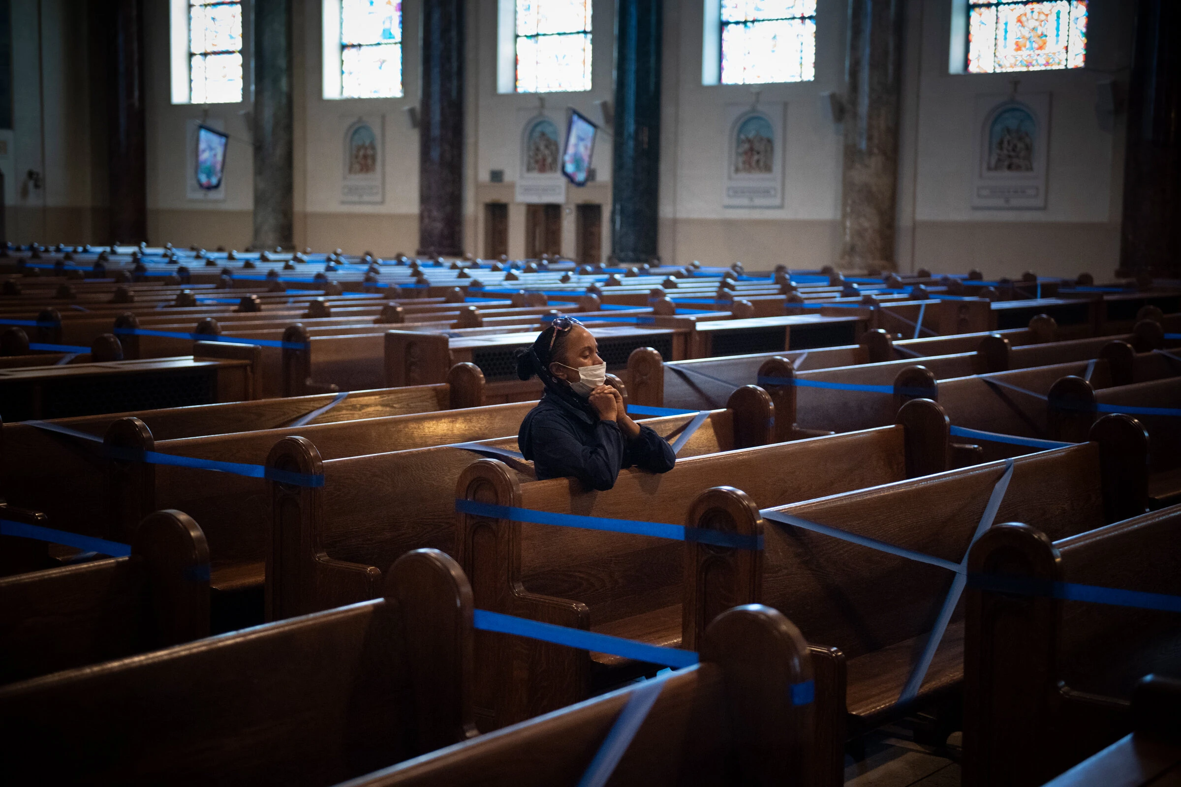 A woman prays alone during the COVID-19 lockdowns at Our Lady of Angels Church in Brooklyn, New York. Credit: Jeffrey Bruno