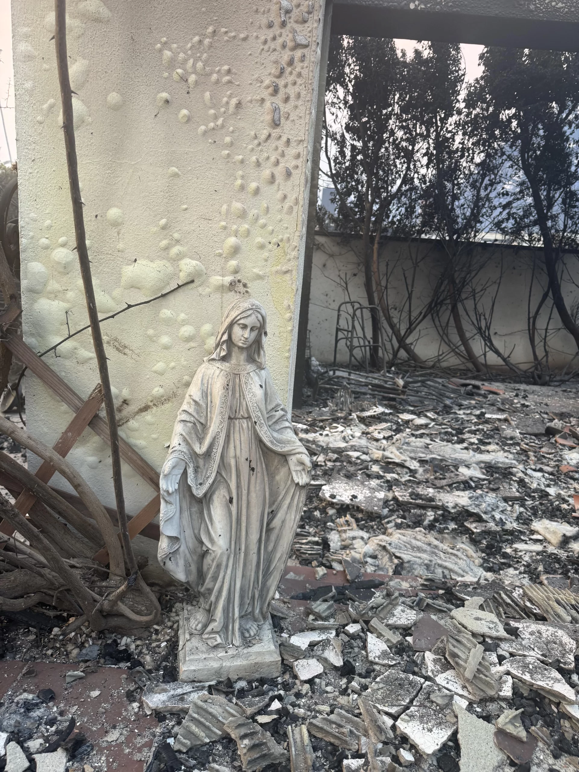 Jennifer and George Magallon lost their home in the Eaton fire on Jan. 8, 2025. But Jennifer pointed to one sign of hope: When they returned to the ruin of their home one object stood unscathed amid the rubble — an outdoor statue of the Blessed Mother. Credit: Photo courtesy of Jennifer and George Magallon