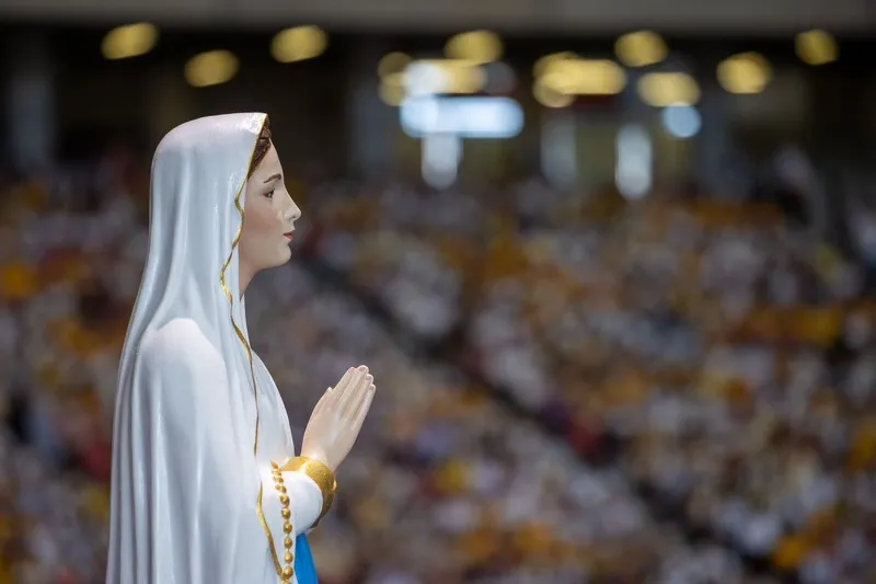 A statute of Mary overlooks the crowd at the papal Mass at Singapore National Stadium on Thursday, Sept. 12, 2024. Credit: Daniel Ibáñez/CNA