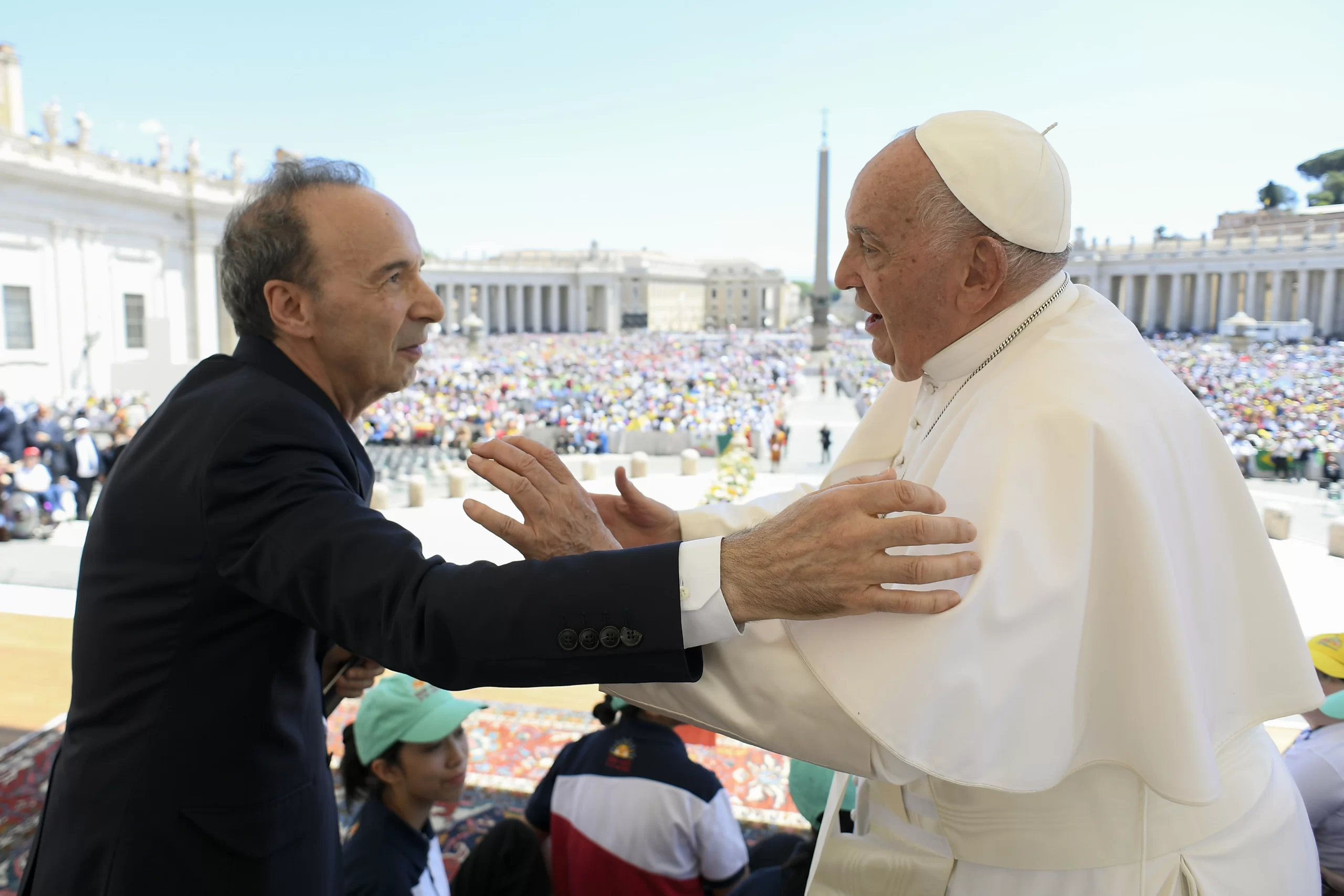 The pope greets Italian actor Roberto Benigni after the closing procession for World Children's Day in St. Peter's Square at the Vatican on Sunday, May 26, 2024. The actor took the stage for a lively and inspirational monologue that combined good humor with a call for children to read and to dream. Credit: Daniel Ibañez/CNA
