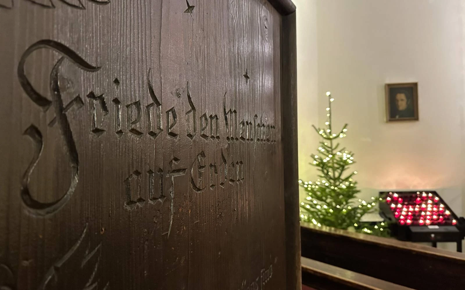 Candles burn behind the entrance to the Silent Night Chapel in December 2024. About 60,000 visitors from around the world come to Oberndorf annually to see the birthplace of "Silent Night." Credit: Rudolf Gehrig/EWTN News