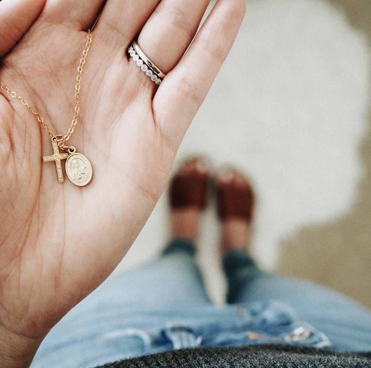 The floral cross and saint necklace from Stella & Tide. Credit: Stella & Tide