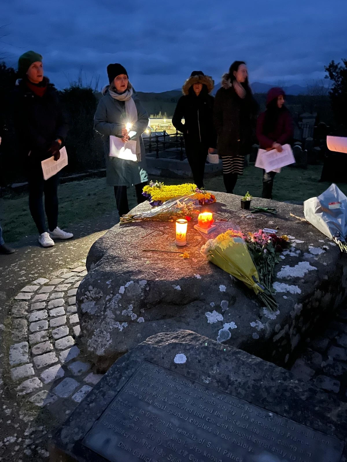 Friends and strangers from all walks of life gather in prayer at dawn on March 17, 2025, around St. Patrick's grave in Downpatrick, County Down, to pray for peace and unity. Credit: Siobhán Brennan