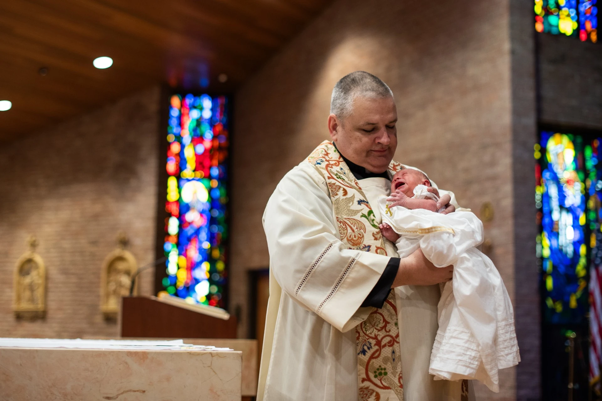 Father John Mosimann baptizes a child at his parish, St. Mary of the Immaculate Conception in Fredericksburg, Virginia. Credit: Ginny Foreman